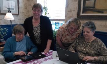Instructor Lucy Cressey (standing, left) assists (from left) Sandra Barth, Cathy Orne and Betty Sullivan in their search for information. JANE CARPENTER/Boothbay Register