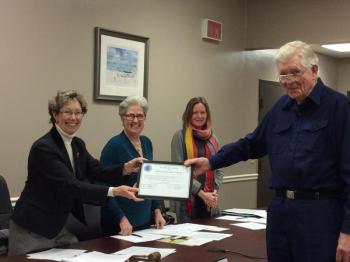 Palmer Payne, right, receives his surprise award from Board Chairman Denise Griffin, left, while selectmen Wendy Wolf (center left) and Tricia Warren (center right) look on. KATRINA CLARK/Boothbay Register