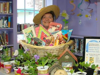 Mary Pinkham, lover of books, children and costumes, promotes a spring plant sale at the Boothbay Harbor Memorial Library. File photo