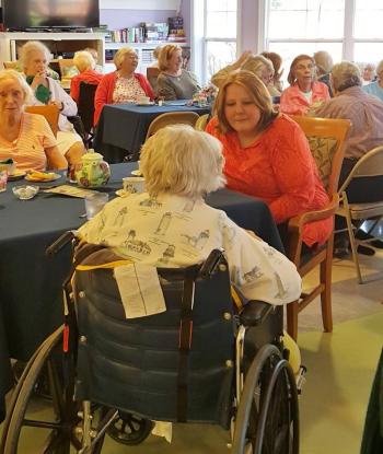 Photo taken during the Tea. Jerie Phinney said, "I love the pictures that show the volunteers interacting with the residents. That made it especially lovely." Courtesy of St. Andrews Village.
