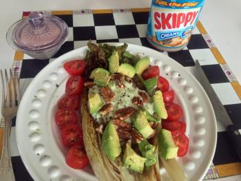 Grilled romaine with sliced grape tomatoes and avocados looks gorgeous on a pretty plate. SUZI THAYER/Boothbay Register
