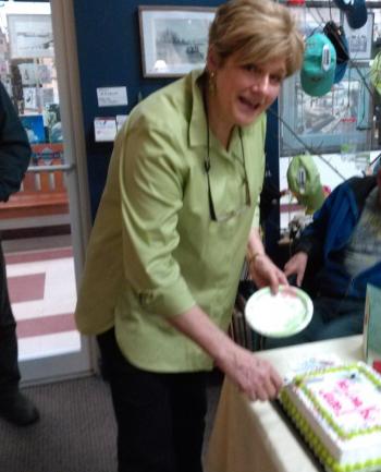 Jane Good cuts the cake at the surprise “thank you” party given for her at the community center. JANE CARPENTER/Boothbay Register