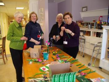 From left, Margaret Holden, Nan Jackson, Pat McMurray and Karen Gilbert making preparations for the April Garden Therapy craft that was used to decorate tables at the Volunteer Tea. Courtesy of Kathleen Marty