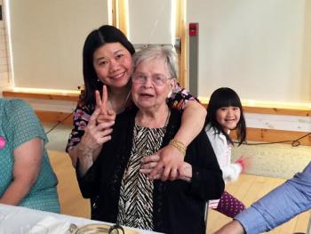 Hang Nguyen hugs her friend, Valerie Smith, while Nguyen’s daughter, Chau, photobombs them. SUZI THAYER/Boothbay Register