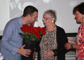 Valerie Smith was presented with 100 long-stemmed red roses at her 100th birthday party. Here her grandson, Alex Jackimovicz, gives her a portion of them. Courtesy of Shri N. A. Verrill