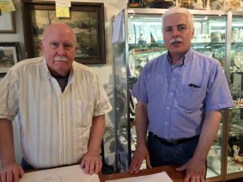 Ted Talbert, left, and Tim Buckowski at the front desk of their antiques business in Wiscasset, Showcase Antiques Gallery. SUZI THAYER/Boothbay Register