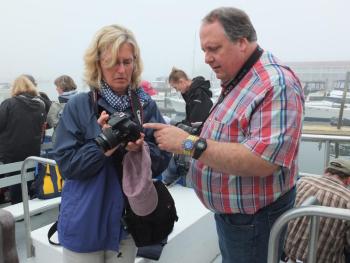 Michael Leonard assists a photographer on the cruise. SUZI THAYER/Boothbay Register