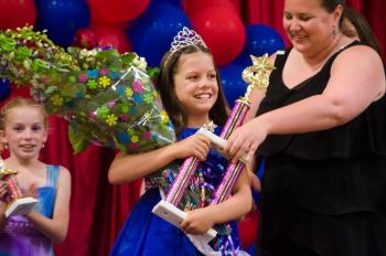 Emerson Harris is presented her trophy and flowers by emcee Emily Mirabile after being crowned the winner of the Miss Windjammer Pageant 2016 at the the Boothbay Region YMCA. At left is third place finisher Hannah Hills. Courtesy of Peter Southwick