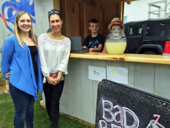 Two women from Lithuania, who are working in Boothbay Harbor for the summer, stopped for a glass of lemonade on June 21. SUZI THAYER/Boothbay Register