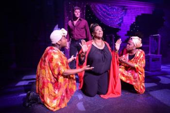 Psychic Oda Mae Brown (E.Faye Butler, kneeling, center) prays to have her “gift” taken from her — now that she can really hear a ghost –- Sam Wheat (Gregg Goodbrod). Oda Mae’s “assistants” are Linnaia McKenzie and Janelle McDermoth. Courtesy of Roger S. Duncan