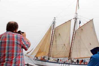 Micheal Leonard takes a shot of a Windjammer as it makes its way into Boothbay Harbor on June 29. SUZI THAYER/Boothbay Register