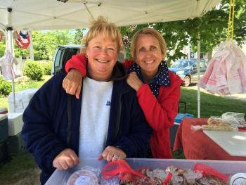 Tracy Penniman, left, and her helper Bonnie Nielsen at the Pemaquid Lobster & Seafood booth at the Boothbay Farmers’ Market on June 9. SUZI THAYER/Boothbay Register