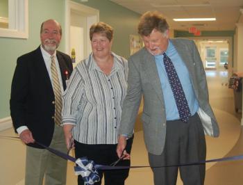 Laurie Zimmerli flanked by LincolnHealth officials James Donovan (left) and Bill Logan as they cut the ribbon on June 24. ART MAYERS/Boothbay Register