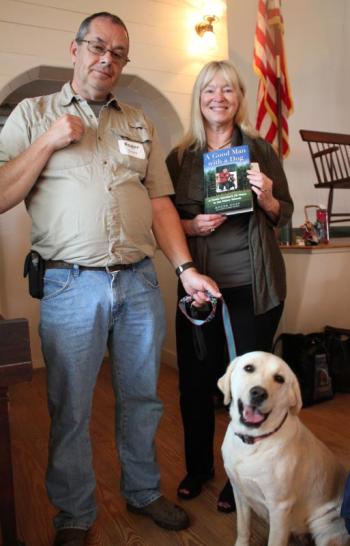 Roger Guay, Kate Clark Flora and Nilla pose for a photo with their new book, “ A Good Man with a Dog.” SUE MELLO/Boothbay Register Photo of Kate Flore, Roger Guay