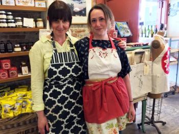 Dana Browne-Spinney and a co-worker sport some PaperDoll Aprons, at Treats in Wiscasset. SUZI THAYER/Boothbay Register