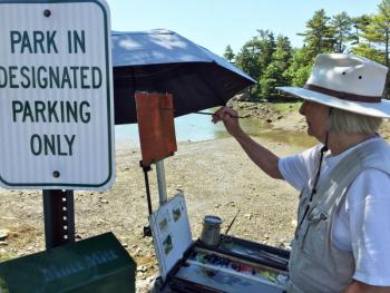 Corinne McIntyre, who started the group, Plein Air Painters of Maine, was painting at the entrance to Knickercane Island on July 13. SUZI THAYER/Boothbay Register