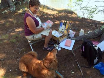 Livy Glaubitz, from Bath, was with the group of plein air painters on Knickercane Island on July 13. Her best friend, Schooner, provided adoration. SUZI THAYER/Boothbay Registerand Schooner