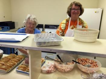 Lobster roll makers Betty Goulette, left, and Laurie Bean, at the Southport Country Fair and Lobster Roll Luncheon on July 20. SUZI THAYER/Boothbay Register