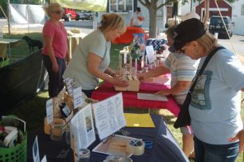 Mutt Scrub attendees look over raffle items. ART MAYERS/Boothbay Register