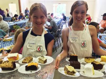 Erin Russell, left, and her sister Molly serve cakes at the Southport Country Fair and Lobster Roll Luncheon on July 20. SUZI THAYER/Boothbay Register