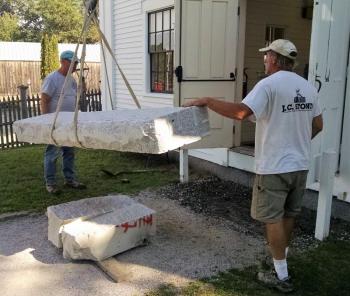 Getting the first step into position Aug. 25 at the 1847 Town Hall at the Boothbay Railway Village Musuem. Installation of new granite steps at Boothbay Railway Village Town Hall Boothbay ME