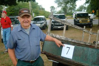 Contractor and amateur auctioneer Elbridge Giles inspects a donated trailer. ART MAYERS/Boothbay Register