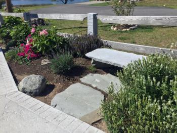 A stone bench, donated by someone in memory of his wife, at the east end of the footbridge. SUZI THAYER/Boothbay Register