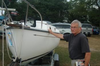 Bob Gill eyes a sailboat donated for the live auction. ART MAYERS/Boothbay Register