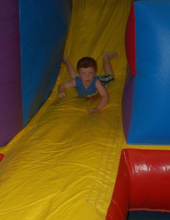 Dylan Chryplewicz tries out the inflatable slide. ART MAYERS/Boothbay Register