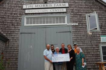 First National Bank presents a donation to Morris Farm. Pictured are, from left, Jack Swanton, treasurer; Marvin Tala, AmeriCorps VISTA volunteer; Merry Fossel, board co-president; Les Fossel, board co-president; Monique McRae, branch manager, First National Bank; Russ Cloutier, store manager; and Pat Cloutier, administrative assistant/programming. Courtesy photo