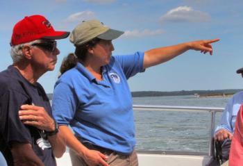 Sarah Gladu, director of Education and Environmental Monitoring at the Damariscotta River Association, will discuss the past and present of oysters in the Damariscotta River at Schooner Cove on Sept. 7. Sarah and the Damariscotta River Association have a long history with Schooner Cove. Sarah is pictured here pointing out a feature of interest during a boat tour with Schooner residents. Courtesy photo