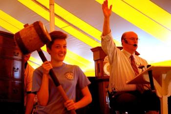 Mikayla Hardy assists auctioneer Bob Foster in selling an antique mallet. ART MAYERS/Boothbay Register