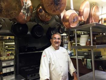 Mario De Pietro in his Squire Tarbox kitchen. Most of the copper pots and pans belonged to his parents. SUZI THAYER/Boothbay Register