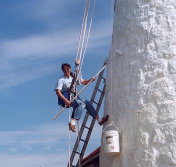 Elaine painting the tower during the restoration of Burnt Island. Courtesy of Elaine Jones