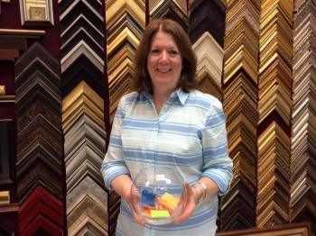 Susan Brackett of Boothbay Harbor Framers holds a fishbowl with Monday’s “Jeopardy” guesses. Will one of those names win the grand prize on Sept. 10? KATRINA RICKERMANN/Boothbay Register