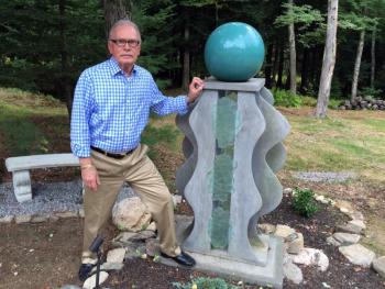 Thomas Cramer stands with one of his sculptures in his backyard in Wiscasset. SUZI THAYER/Boothbay Register