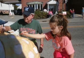 Bea Poole and grandfather Dewey Chase work on a tribute to David Ortiz. ART MAYERS/Boothbay Register