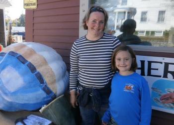 Susan Bartlett Rice and daughter Amelia carve on a pumpkin they grew. ART MAYERS/Boothbay Register