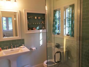 The downstairs bathroom has a glass-walled shower. SUZI THAYER/Boothbay Register
