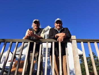 Steve Malcom, left, and Scott Larson on the front deck of their new venture, the Russell House Bed & Breakfast. SUZI THAYER/Boothbay Register