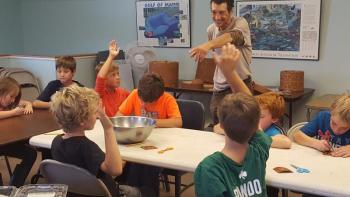 Students from St. George School in Tenants Harbor participate in DRA’s Wabanaki program and learn about birch bark and its importance to native people with Passamaquoddy educator David Moses Bridges. Courtesy photo