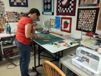 Maggie Brown lays out a design for a quilt. SUZI THAYER/Boothbay Register