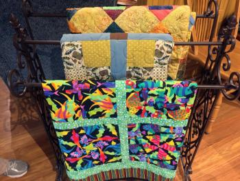 A rack of quilts made by the Kwilts 4 Kidz women. SUZI THAYER/Boothbay Register