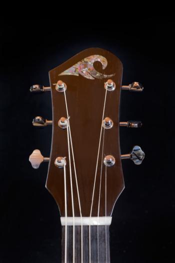 Big Wave Guitars logo, always in abalone, inspired by the hokens art waves painted by Japanese watercolor artists, on an ebony headplate. Courtesy of Mike Gerstner Big Wave Guitars logo