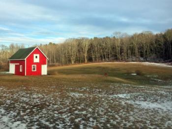 A small red barn lights up an otherwise drab landscape. SUZI THAYER/Boothbay Register