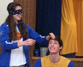 A blindfolded Kate Friant applies makeup to Grant Giles. MORGAN CALLAN ROGERS/Boothbay Register