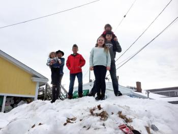 Violet Baldwin, left, Jackson Lorrain, Wyatt Lorrain, Suzie Edwards, Charles Chappelle and Emily Conley gather on a big pile of snow on Pier One outside McSeagull’s on Feb. 19. SUZI THAYER/Boothbay Register