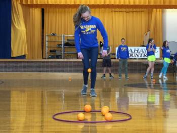 Amy Case competes in the hold-an-orange-between-your-knees-and-get-it-in-the-hoop competition during the BRHS pep rally. It was hard to figure out who won. MORGAN CALLAN ROGERS/Boothbay Register