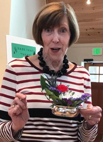 BRGC Horiculture Chair Irene Gerny offers an informal critique of several demure "Flowers for Fun" arrangements at the Feb.8 meeting of the Garden Club. The theme, Silver Bells, emphasized the size and effective use of shiny containers. The design program was followed by a themed potluck luncheon. Courtesy photo