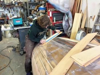 Sarah Nutt shows how to fair a hull. SUZI THAYER/Boothbay Register